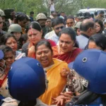 Destruction in Sandeshkhali following the violence, showcasing damaged buildings and streets.