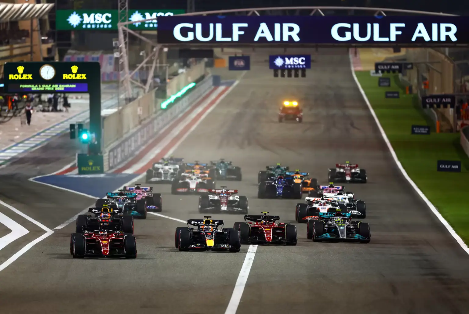 A close-up of a Formula 1 car navigating a sharp turn on the Bahrain track, demonstrating the precision and speed of F1 racing.