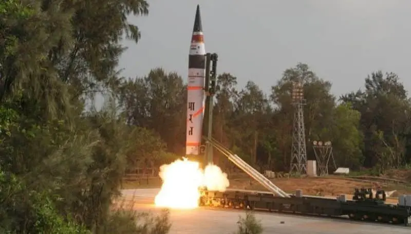 Engineers and scientists celebrating the successful test-firing of the Agni-V, a milestone in India's defense program.