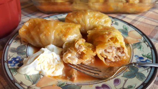 A pot of simmering Sarmale with layers of cabbage rolls and rich tomato sauce