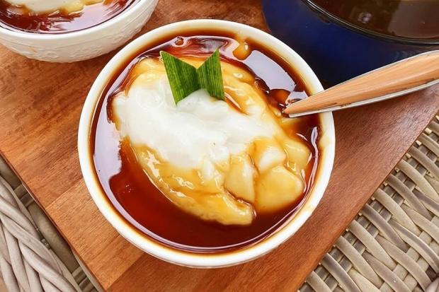 Semangkuk Bubur Sumsum yang lembut dan manis, disiram dengan sirup gula merah dan dihiasi daun pandan segar