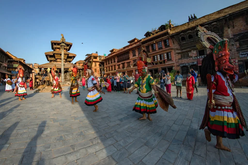 Colorful celebration during Bisket Jatra festival in Bhaktapur with decorated chariots and traditional music. 