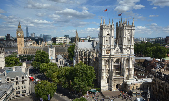 The impressive nave of Westminster Abbey with stained glass windows. 