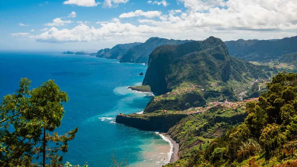 Dramatic cliffs and lush greenery of Madeira's coastline.