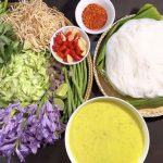 A beautifully plated bowl of Nom Banh Chok, showcasing fresh rice noodles